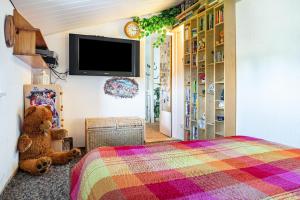 a bedroom with a teddy bear sitting next to a bed at Ostseeblick in Kröslin