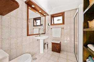 a bathroom with a toilet sink and a mirror at Villasal in Playa Blanca +15 photos