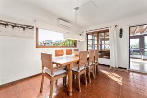 a dining room with a table and chairs at Villasal in Playa Blanca