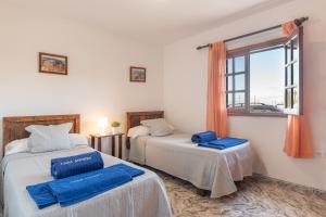 a bedroom with two beds and a window at Andres House, Tías in Tías