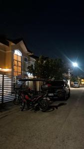 a group of motorcycles parked next to a building at night at Lancaster new city in General Trias