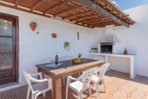 a kitchen with a wooden table and chairs and an oven at Andres House, Tías in Tías