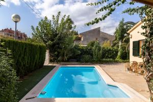 a swimming pool in the yard of a house at Oleanda in Alcudia