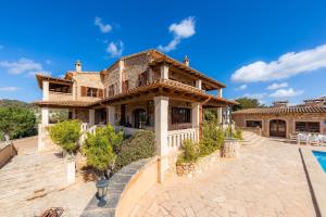 an image of a house with a swimming pool at Turó de na Roca in S'Horta