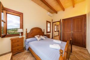 a bedroom with a bed and a window at Turó de na Roca in S'Horta +22 photos