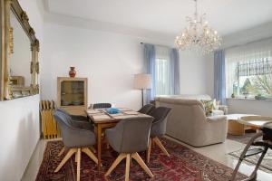 a living room with a table and chairs and a couch at Thaicenter Bodensee 2 in Friedrichshafen