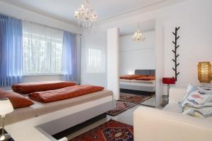 a bedroom with two beds and a couch in it at Thaicenter Bodensee 2 in Friedrichshafen