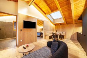 a living room with a couch and a table at Huetterhof Apartement Herbischt in Caines