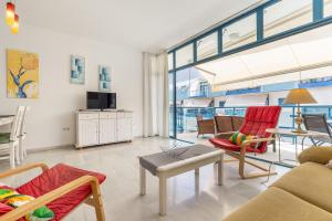 a living room with a couch and chairs and a table at Piso Castell in Castell de Ferro