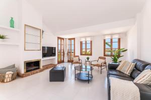 a living room with a couch and a fireplace at Ca Na Luisa-Residential Area in Palmanova
