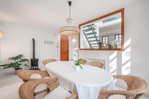 a white dining room with a white table and chairs at Ca Na Luisa-Residential Area in Palmanova