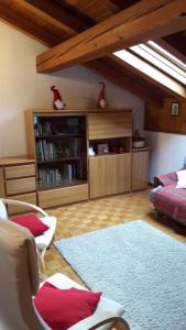 a living room with a bed and a book shelf at Mansarda le Chateau in Aymavilles