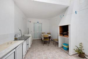 a kitchen with a sink and a table at Apartment T2 Malveiro in Odeceixe