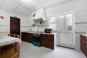 a kitchen with a stove and a sink at Apartment T2 Malveiro in Odeceixe +12 photos