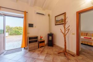 a living room with a tv and a window at Casa vacanza Macciunitta in Arzachena