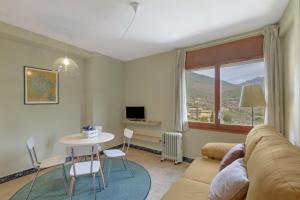 a living room with a couch and a table at El Campanar in Sant Llorenç de Morunys