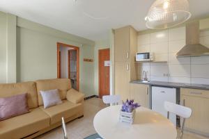 a living room with a couch and a table at El Campanar in Sant Llorenç de Morunys