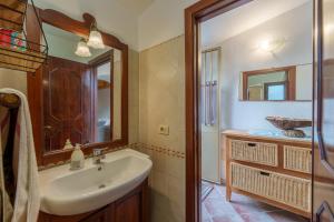 a bathroom with a sink and a mirror at Casa vacanza Macciunitta in Arzachena +15 photos