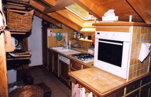 a kitchen with a sink and a stove top oven at Chalet La Grangette in Abondance
