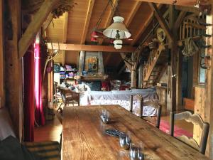 a large wooden table in a room with a couch at Chalet La Grangette in Abondance