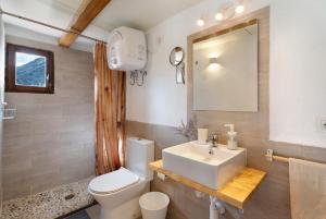 a bathroom with a sink and a toilet and a mirror at Casa Tajaraste 2 in Hermigua +29 photos