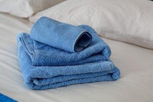 a blue towel sitting on top of a bed at Affittacamere Angelina in San Pietro di Cadore +27 photos