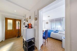 a room with a bed and a refrigerator in it at Affittacamere Angelina in San Pietro di Cadore