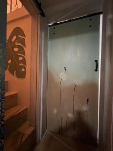 a glass door with dandelions and butterflies on it at Casa Do Mestre Lau in Terena +25 photos