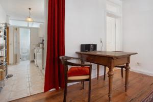 a wooden desk with a chair in a room at Ferienwohnung Bett Und Buch in Lychen +61 photos