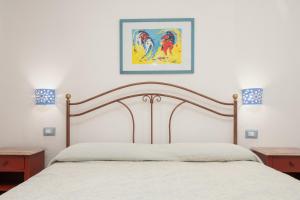 a bedroom with a bed and a picture on the wall at Seahouserent in Cannigione