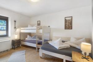 a bedroom with two bunk beds and a desk at Ferienhaus alte Münze in Neuerburg +18 photos