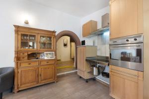 a kitchen with wooden cabinets and a counter top at Ferienhaus alte Münze in Neuerburg