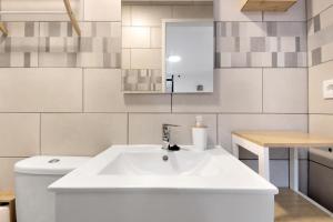 a white bathroom with a sink and a toilet at Df Alojamentos e Suites in Coimbra +72 photos