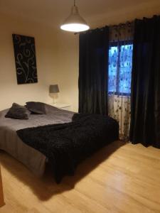 a bedroom with a large bed and a window at Fernandes Apartment in Carvoeiro +9 photos
