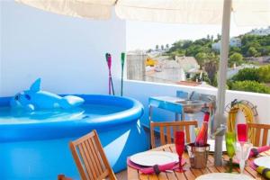 a patio with a pool and a table and chairs at Fernandes Apartment in Carvoeiro