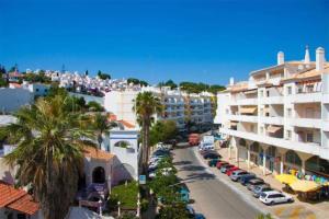 arial view of a city with buildings and palm trees at Fernandes Apartment in Carvoeiro