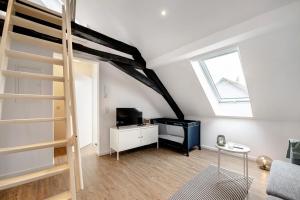 a living room with a loft bed and a television at Adlernest mit Weinbergblick in Trittenheim
