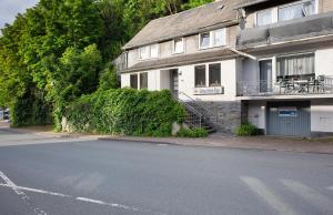 a house with a balcony on the side of the street at Gästehaus Roth in Willingen