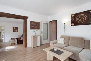 a living room with a couch and a table at Gästehaus Roth in Willingen