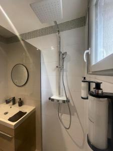 a shower in a bathroom with a sink at Suite cinéma et jacuzzi privé in Melun +32 photos