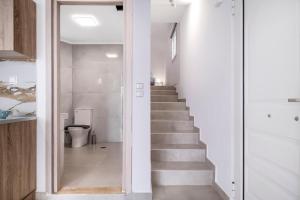 a staircase in a house with a glass door at Scorpios View Meganisi in Meganisi +14 photos