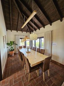 a dining room with a large wooden table and chairs at Villa Laguna - Charmy Villa in Moncarapacho