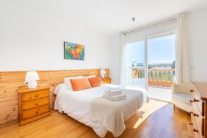 a bedroom with a bed and a large window at Mimosa in Alcudia +18 photos