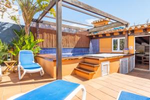 a patio with a bar and a swimming pool at Mimosa in Alcudia