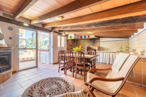 a kitchen with a table and chairs and a fireplace at Mimosa in Alcudia