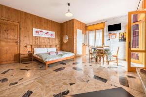 a living room with a bed and a table at App Olivo Casa Demonti in Tignale +26 photos