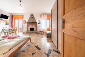 a bedroom with a bed and a fireplace at App Olivo Casa Demonti in Tignale