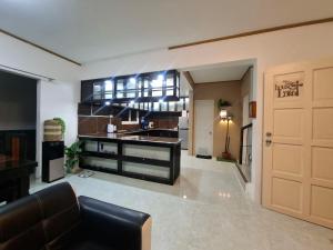 a living room with a kitchen and a door at Lancaster new city in General Trias
