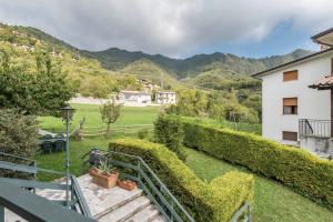 a view from the balcony of a house with a garden at App Olivo Casa Demonti in Tignale