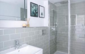 a bathroom with a shower and a sink and a mirror at Duplex Apartment - Central Harrogate Apartment in Harrogate